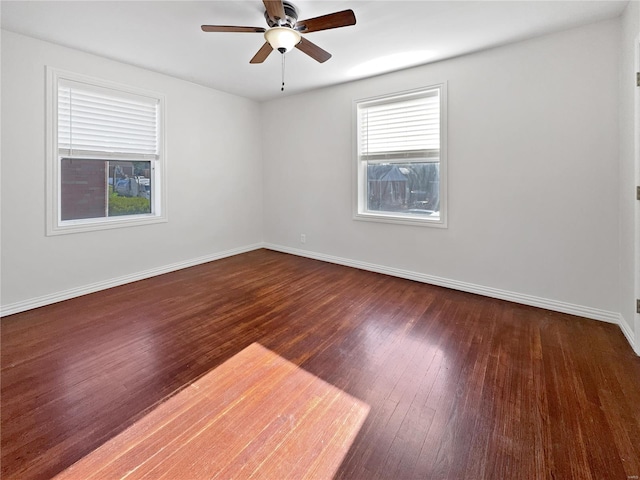 unfurnished room featuring dark wood-type flooring and ceiling fan