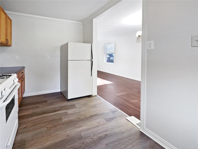 kitchen featuring ornamental molding, white appliances, and dark hardwood / wood-style flooring