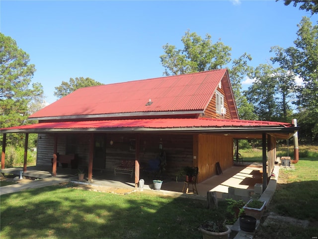 view of side of home featuring a patio and a yard