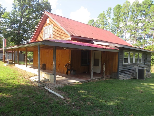 back of house featuring a yard and cooling unit