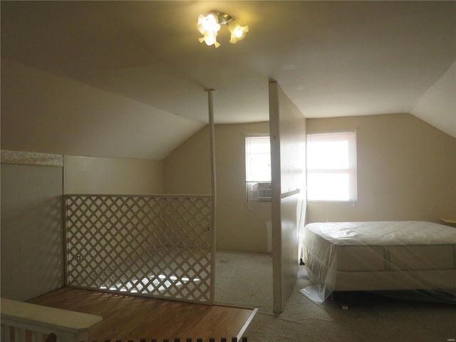 bedroom featuring lofted ceiling and carpet