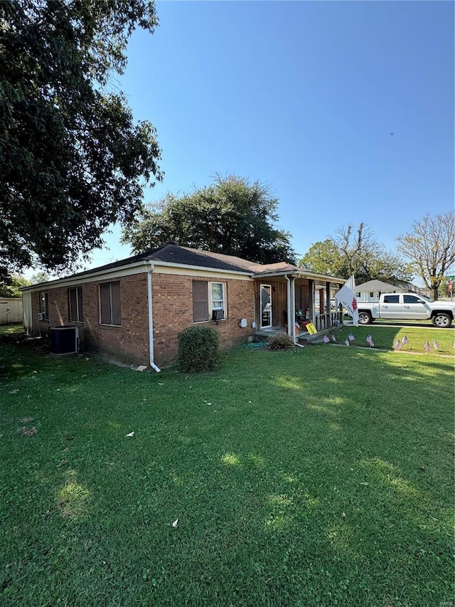 ranch-style house featuring central AC and a front lawn