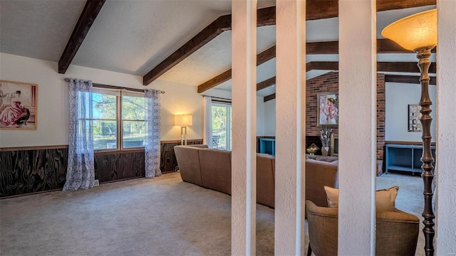 interior space featuring beamed ceiling and a brick fireplace