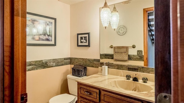 bathroom with toilet and vanity