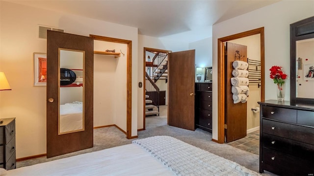 carpeted bedroom with a closet and a walk in closet