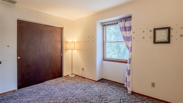 unfurnished bedroom featuring carpet floors and a closet