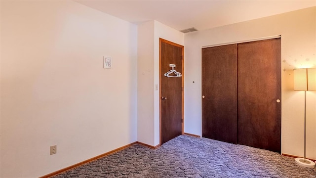 unfurnished bedroom featuring carpet floors and a closet