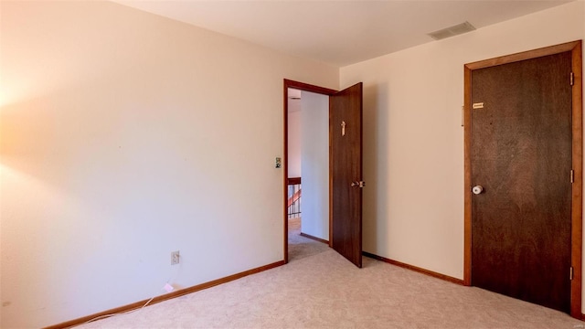 unfurnished bedroom featuring light colored carpet