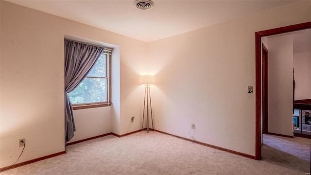 unfurnished room with light colored carpet