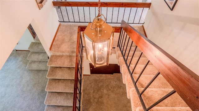 stairway featuring carpet floors