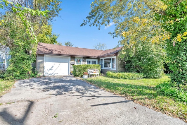 view of front of property with a front yard and a garage