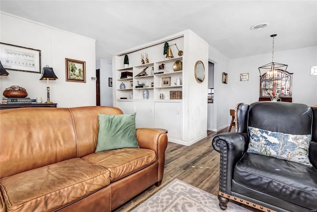 living room featuring an inviting chandelier and wood-type flooring