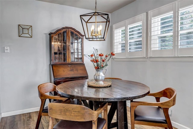 dining space with a notable chandelier and wood-type flooring