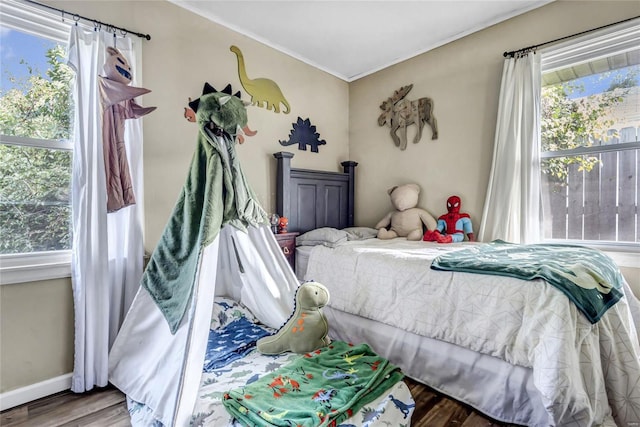 bedroom featuring crown molding and wood-type flooring