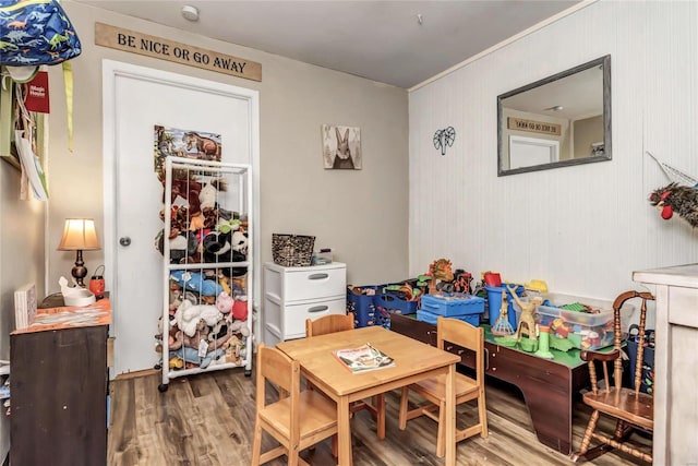 rec room featuring hardwood / wood-style floors and wooden walls