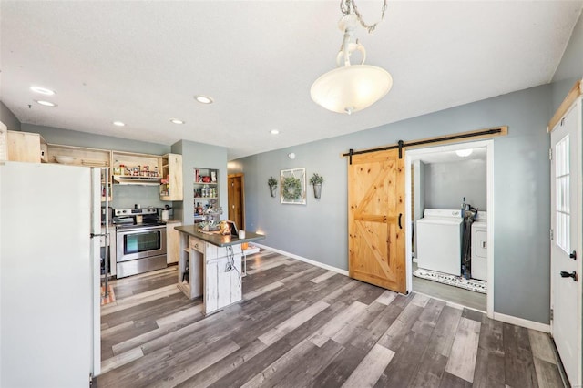 kitchen featuring electric range, washer and dryer, a barn door, pendant lighting, and white refrigerator