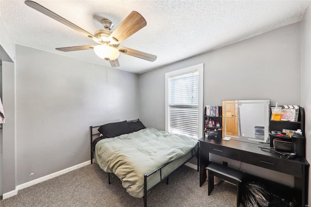 bedroom featuring a textured ceiling, carpet flooring, and ceiling fan