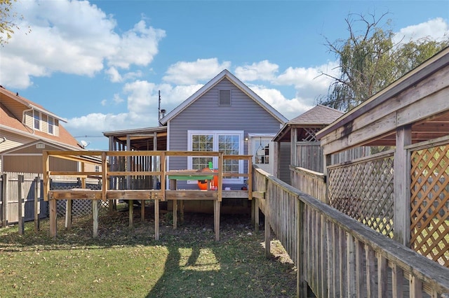 back of house featuring a yard and a deck