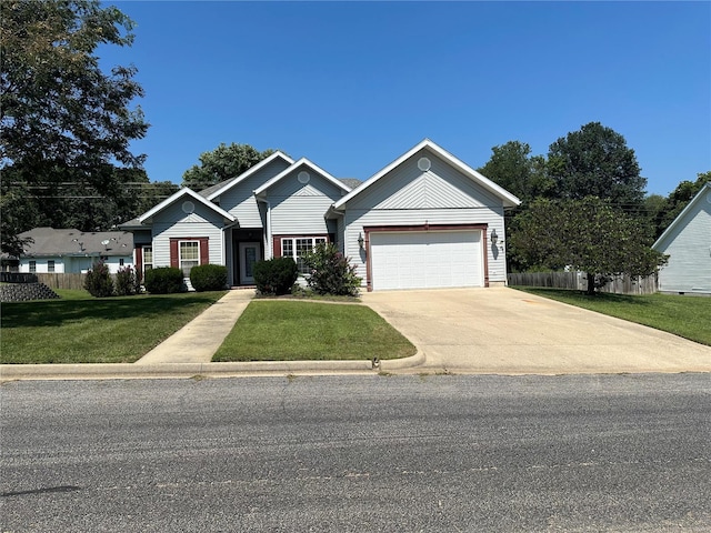 ranch-style house with concrete driveway, a front yard, fence, and an attached garage