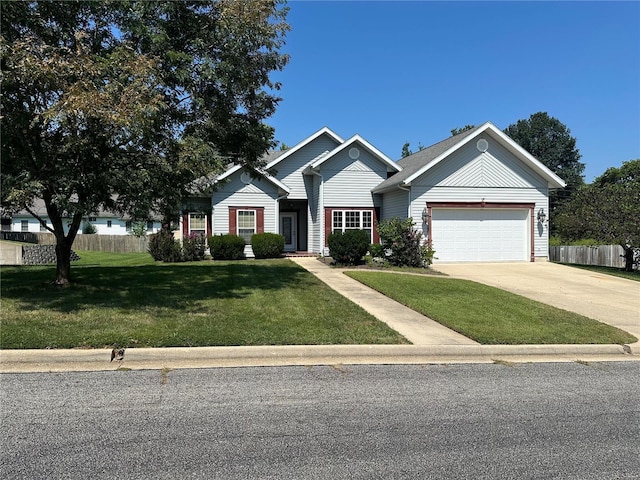 view of front of home featuring a garage, driveway, fence, and a front lawn