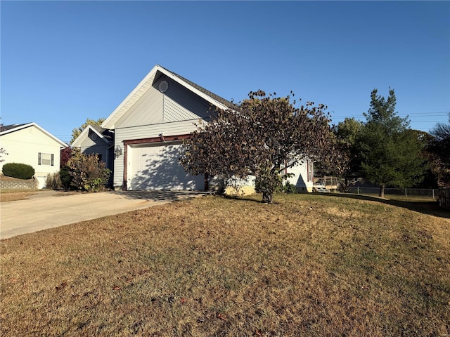 view of front of home with a front lawn and a garage