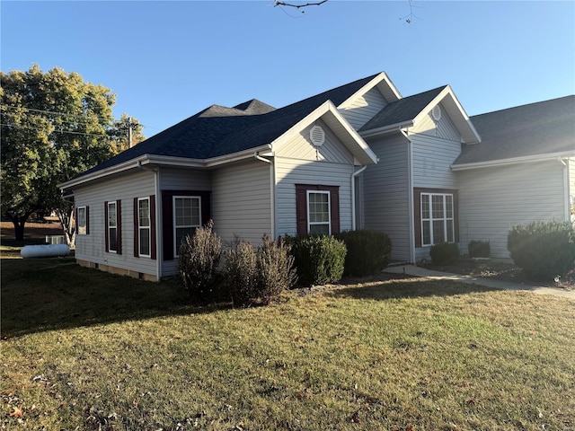 view of side of property featuring a yard