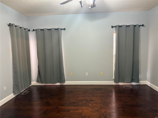 spare room with a textured ceiling, wood-type flooring, and ceiling fan