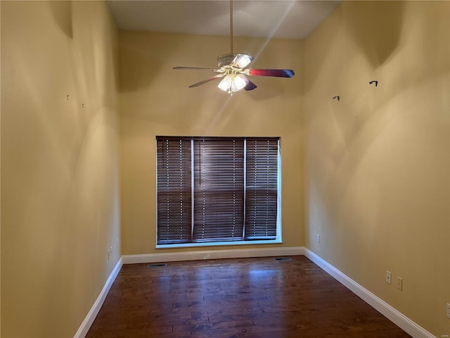 spare room featuring ceiling fan and dark hardwood / wood-style flooring