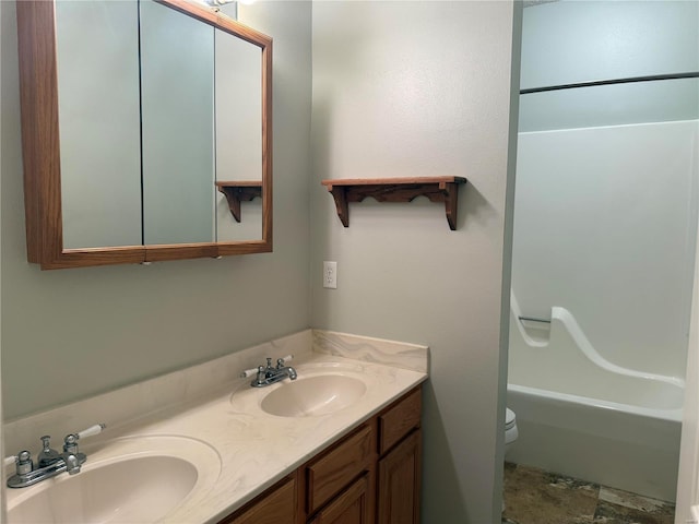 full bathroom with vanity, shower / tub combination, and toilet