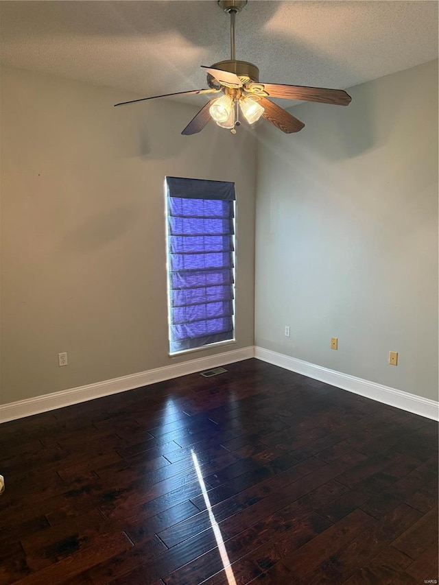 unfurnished room featuring dark wood-type flooring, ceiling fan, and a textured ceiling