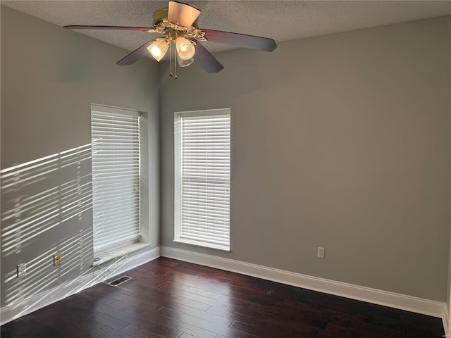 unfurnished room featuring dark wood-type flooring, a textured ceiling, and ceiling fan