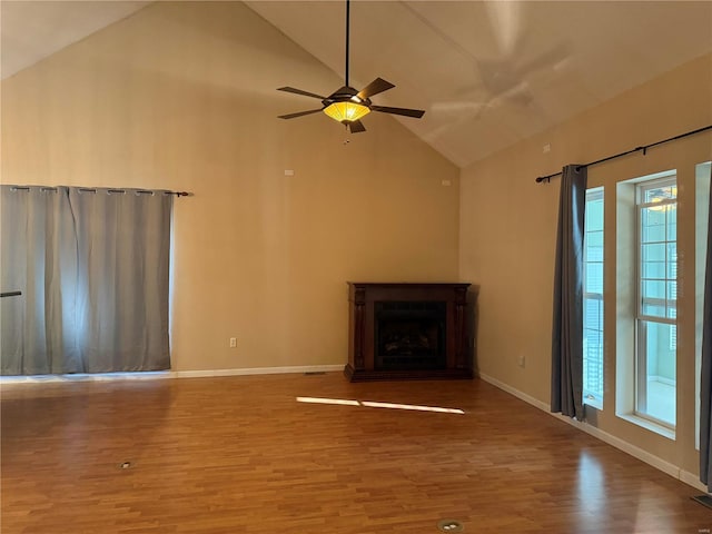 unfurnished living room with ceiling fan, high vaulted ceiling, and wood-type flooring