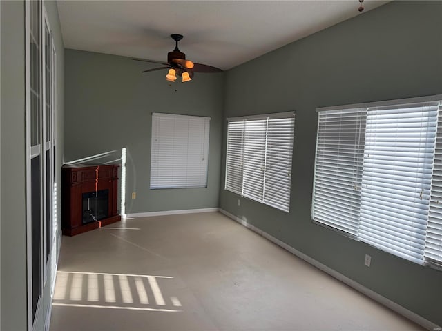 unfurnished living room featuring concrete flooring and ceiling fan