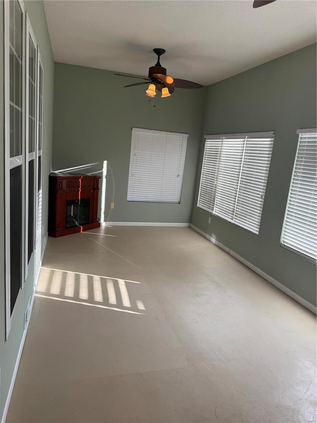 unfurnished room featuring a textured ceiling and ceiling fan