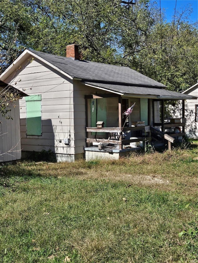 exterior space with covered porch and a front yard