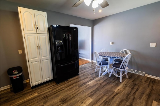 dining area with ceiling fan and dark hardwood / wood-style flooring