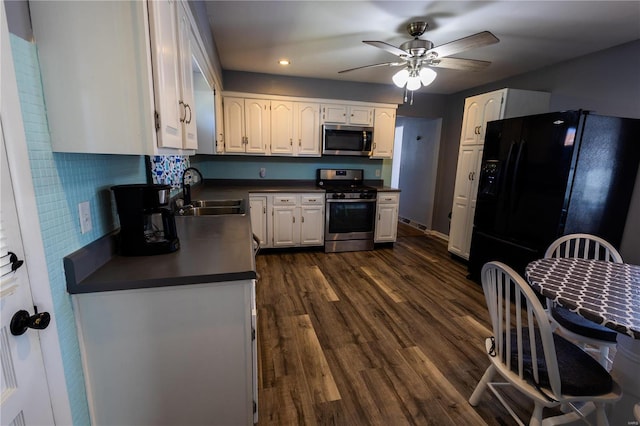 kitchen featuring dark hardwood / wood-style floors, backsplash, sink, white cabinets, and appliances with stainless steel finishes