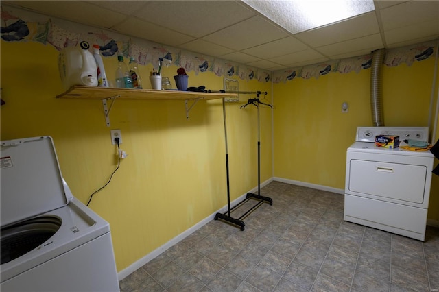 laundry room with independent washer and dryer and light tile patterned flooring