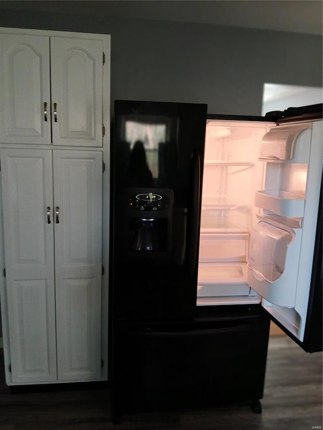 kitchen featuring white cabinetry, dark hardwood / wood-style flooring, and black fridge with ice dispenser