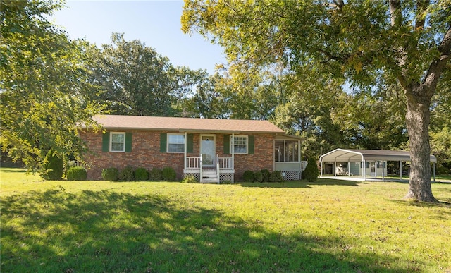 ranch-style home with a front lawn and a carport