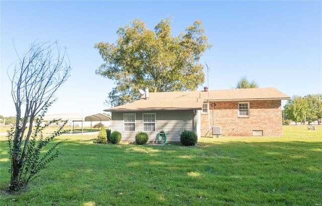 back of property featuring a yard and cooling unit