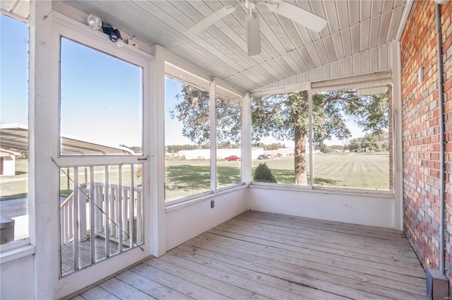 unfurnished sunroom with ceiling fan and a wealth of natural light