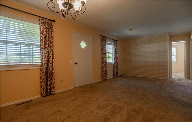 carpeted foyer entrance featuring a chandelier