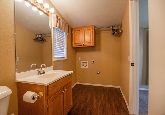 bathroom featuring toilet, vanity, wood-type flooring, and vaulted ceiling