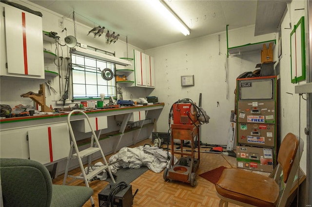 miscellaneous room with a workshop area and light parquet flooring