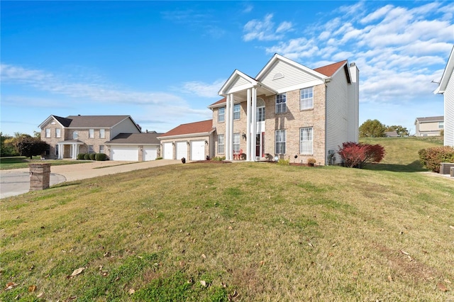 view of front of house with a garage and a front lawn