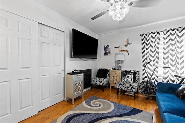 living room featuring ceiling fan and hardwood / wood-style floors