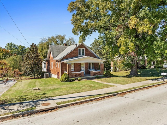 view of front facade with a front yard and central AC unit