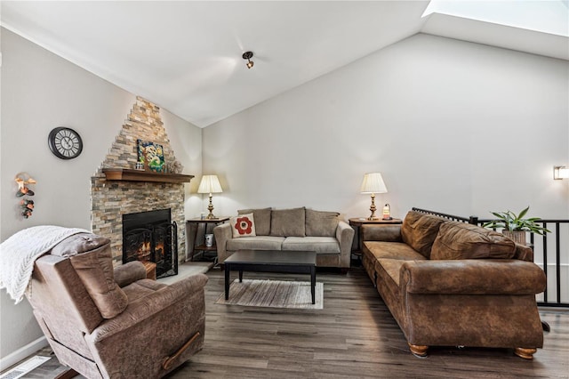 living room featuring dark hardwood / wood-style flooring, a fireplace, and vaulted ceiling