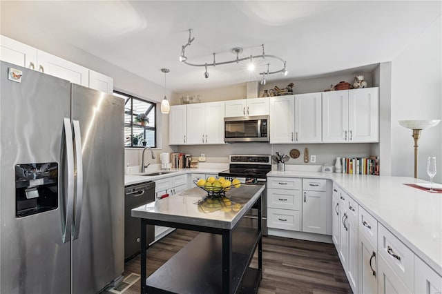 kitchen featuring dark hardwood / wood-style flooring, stainless steel appliances, white cabinetry, and sink